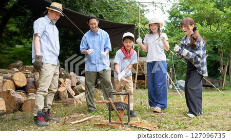 Family and friends enjoying chopping firewood Family and friends enjoying chopping firewood 127096735