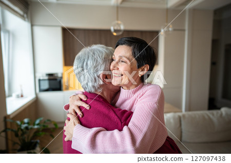 Cheerful happy senior couple hugging celebrating achievement. Happy wife in arms, promotion recovery Cheerful happy senior couple hugging celebrating achievement. Happy wife in arms, promotion recovery 127097438