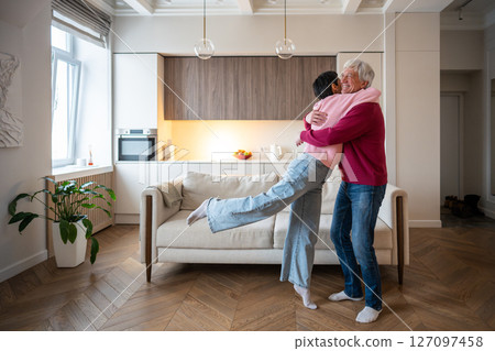 Overjoyed mature wife running into husband arms hug. Senior couple celebration, happy family reunion 127097458