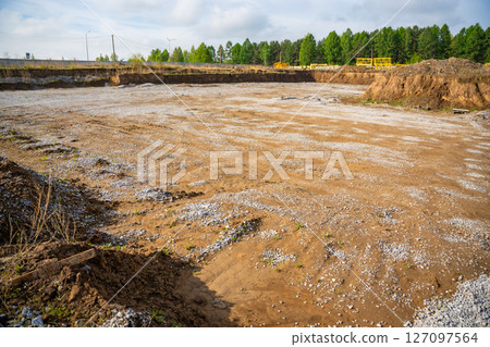 Cleared construction site prepared for building foundation. Excavation area ready for new architectural development and structural work Cleared construction site prepared for building foundation. Excavation area ready for new architectural development and structural work 127097564