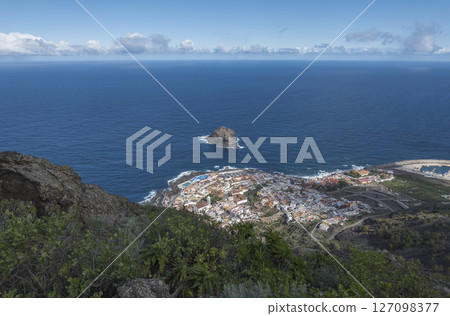 Aerial view of old town Garachico from Mirador de Garachico view point. Colorful houses and harbor. Ocean shore with lava rock pools. Popular tourist destination, Tenerife Canary Islands. Aerial view of old town Garachico from Mirador de Garachico view point. Colorful houses and harbor. Ocean shore with lava rock pools. Popular tourist destination, Tenerife Canary Islands. 127098377