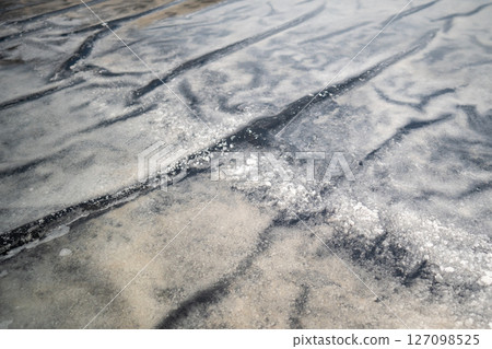 Salt crystallization process underway at Asian fields near village using natural evaporation 127098525