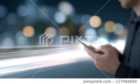 Young man uses mobile device to check impressive 10G download speeds against a vibrant city backdrop Young man uses mobile device to check impressive 10G download speeds against a vibrant city backdrop 127098669