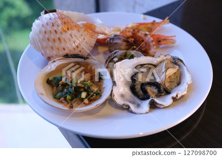 table set with assorted appetizers, seafood, and pastries for festive meal table set with assorted appetizers, seafood, and pastries for festive meal 127098700