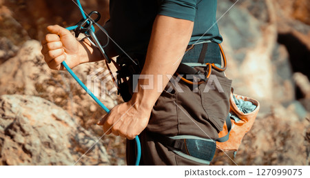 Man is engaged in extreme sports, rock climbing. 127099075