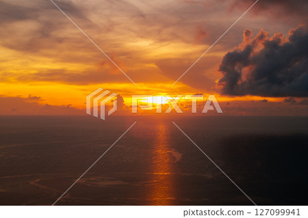 Golden Sunset Beam Reflecting on the Ocean 127099941