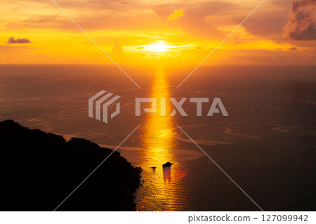 Golden Sunset Beam Reflecting on the Ocean Golden Sunset Beam Reflecting on the Ocean 127099942