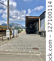 A classic steam locomotive resting in a garage and blue sky 127100114