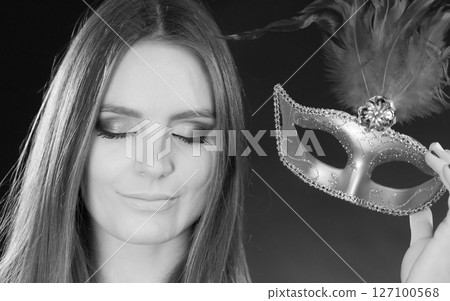 Sensual lady holding carnival mask. Sensual lady holding carnival mask. 127100568