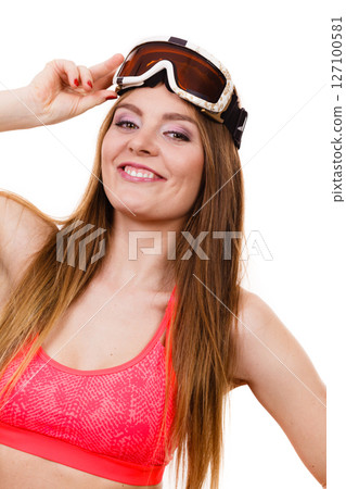 Woman wearing ski suit and goggles on her head Woman wearing ski suit and goggles on her head 127100581