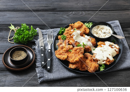 Deep fried Southern chicken thighs with milk gravy 127100636