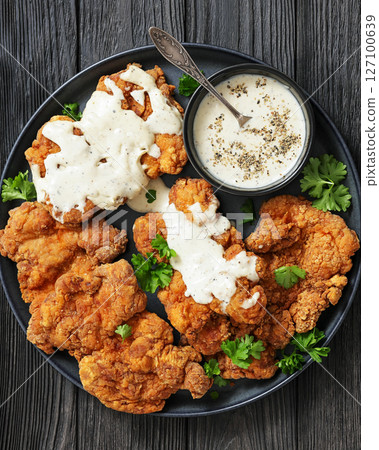 Deep fried Southern chicken thighs with milk gravy 127100639