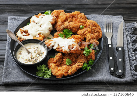 Deep fried Southern chicken thighs with milk gravy 127100640