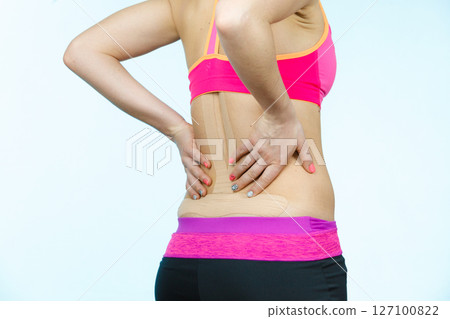 Woman with medical kinesio taping on back Woman with medical kinesio taping on back 127100822