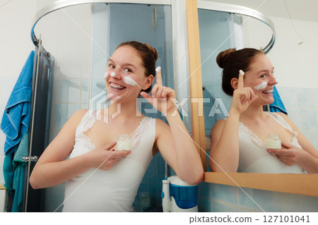 Woman applying moisturizing skin cream. Skincare. Woman applying moisturizing skin cream. Skincare. 127101041