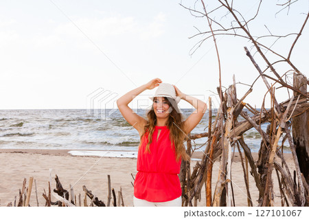 Charming young lady on beach. 127101067