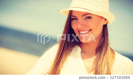 Female tourist resting on beach. 127101089