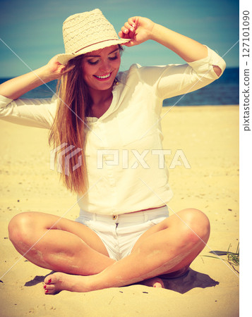 Female tourist resting on beach. 127101090