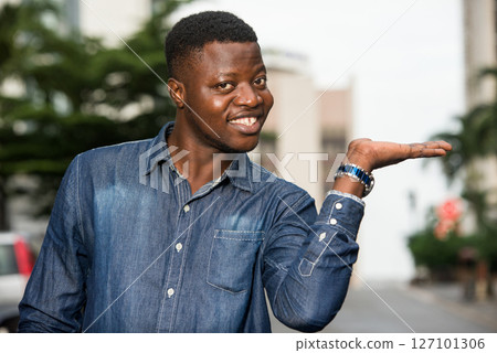 happy man in shirt gesturing a welcome sign happy man in shirt gesturing a welcome sign 127101306