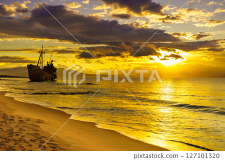 Rusty broken shipwreck on sea shore Rusty broken shipwreck on sea shore 127101320