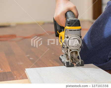 Person cutting floor panels Person cutting floor panels 127101338
