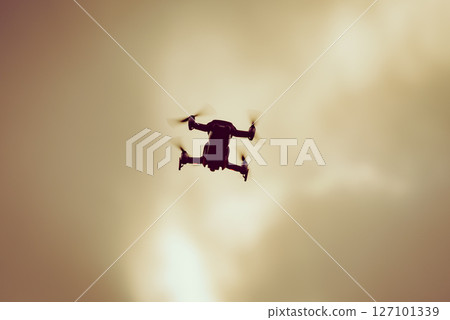 Drone flying over sky background 127101339