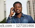 close-up of young african man with mobile phone, happy. close-up of young african man with mobile phone, happy. 127101466