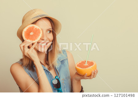 Woman covering her eye with grapefruit. Fun summer 127101498