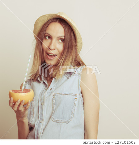 Happy woman in hat drinking grapefruit juice. Diet Happy woman in hat drinking grapefruit juice. Diet 127101502
