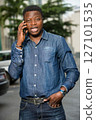 portrait of young african man with mobile phone, happy. portrait of young african man with mobile phone, happy. 127101535