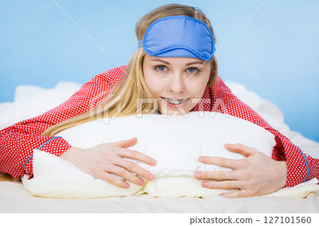 Young woman wearing sleeping eye band in bed Young woman wearing sleeping eye band in bed 127101560