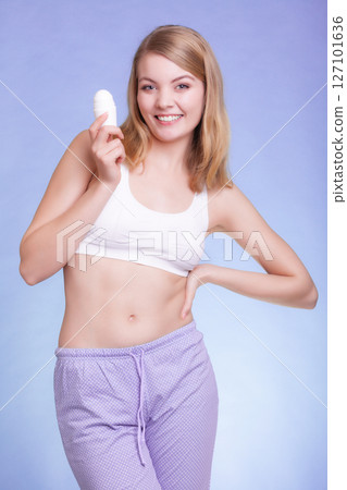 Girl applying stick deodorant in armpit. Skin care Girl applying stick deodorant in armpit. Skin care 127101636