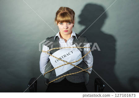 Upset businesswoman bound by contract terms. Upset businesswoman bound by contract terms. 127101673