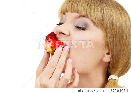 Woman eating cupcake sweet food Woman eating cupcake sweet food 127101684