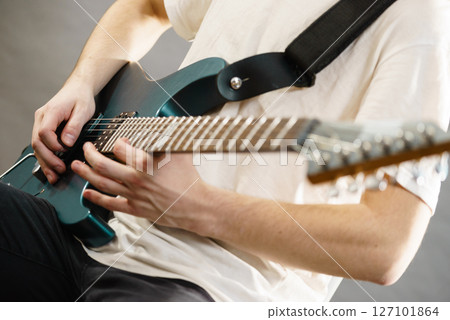 Close up of man playing on electric guitar 127101864