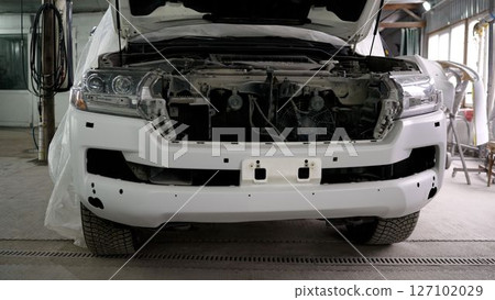 White suv undergoing bumper repair in auto body shop 127102029