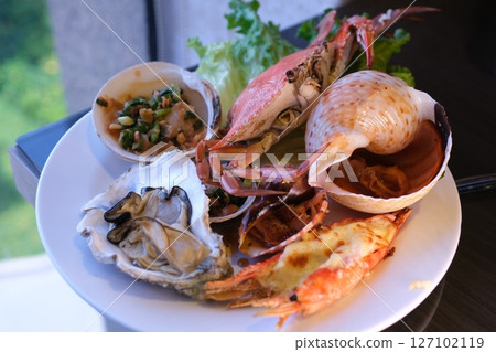 table set with assorted appetizers, seafood, and pastries for festive meal table set with assorted appetizers, seafood, and pastries for festive meal 127102119