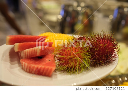 different fruits in the buffet Mango papaya rambutan watermelon guava and others 127102121