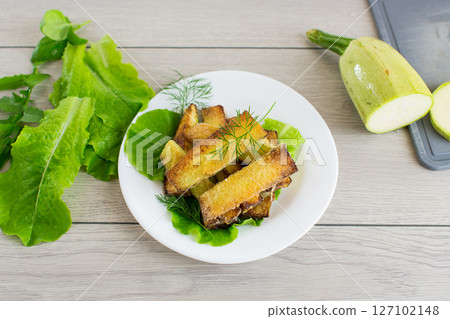 Homemade fried zucchini on a white plate 127102148