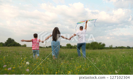 happy family, father mother child kid park, child kid with parents nature, childhood open air, childhood dream, children running field, boy mother father run green meadow, family launching kite into 127102304