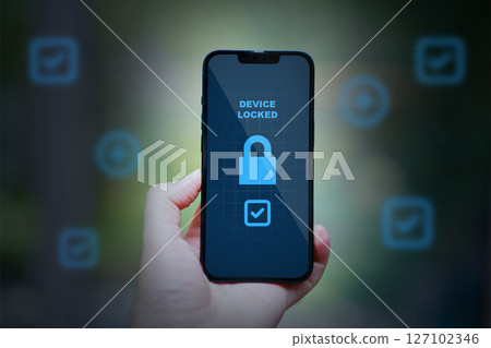 hand holding smartphone with security lock 127102346