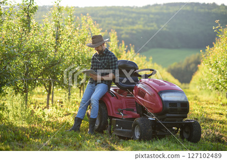 Digital agriculture tools help farmer manage orchard. Digital agriculture tools help farmer manage orchard. 127102489
