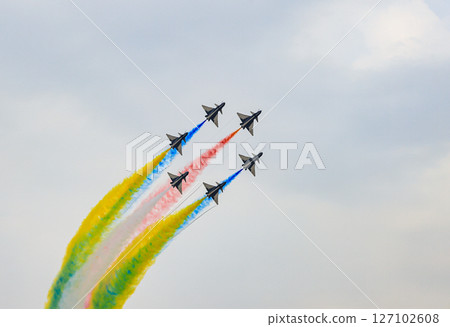 J-10 of China Air Force Aerobatics team on formations with colorful smokes venting from the plane. 127102608