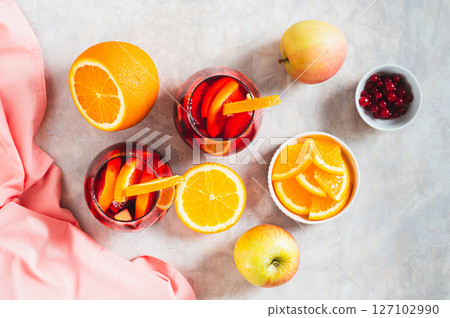Refreshing summer sangria cocktail with fruits and berries in glasses on the table top view 127102990