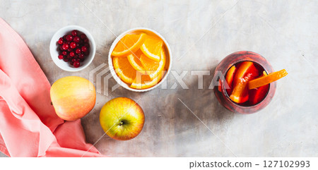 Sangria cocktail with red wine and fruits in glasses on table top view web banner 127102993