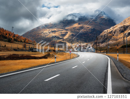 Empty asphalt road in alpine mountains in clouds at sunset Empty asphalt road in alpine mountains in clouds at sunset 127103351