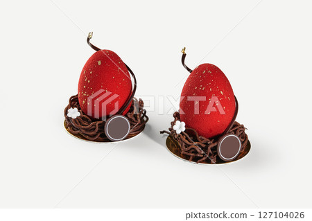 Two red easter eggs sitting in chocolate nests decorated with gold and flowers 127104026