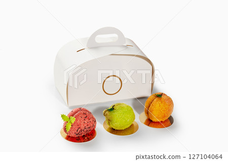 Pastry chef creating fruit shaped desserts with take away box 127104064