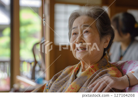A serene scene of an elderly woman and a nurse receiving an infusion at home in a Japanese-style room 127104208