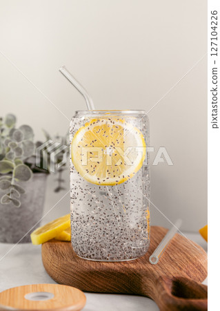 Chia water in a glass on a kitchen wooden board. Healthy detox drink. 127104226